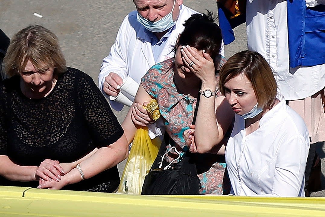 A woman cries as she is taken to an ambulance at the scene of a shooting at School No. 175 in Kazan (AFP via Getty Images)