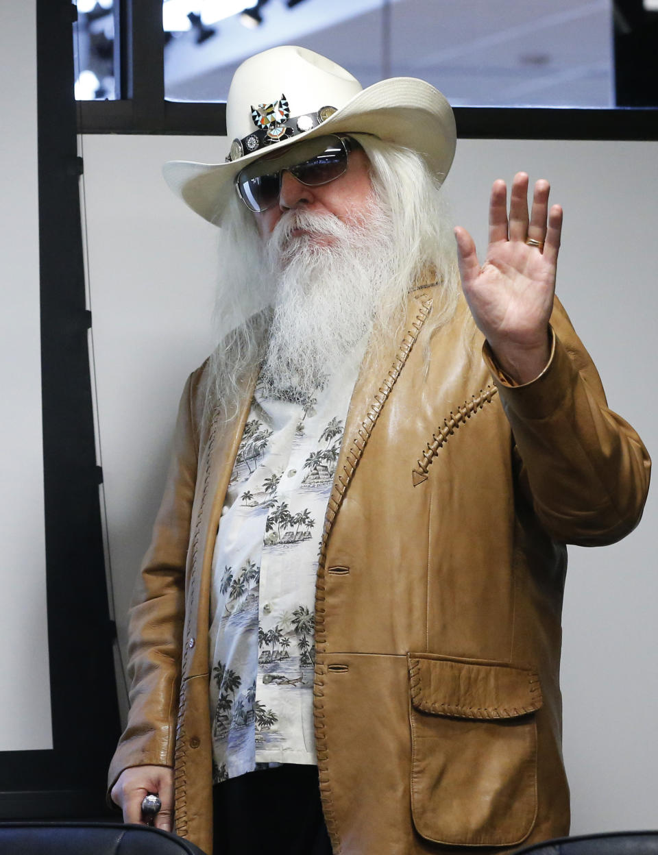 Leon Russell waves as he is introduced in in Tulsa, Okla., Tuesday, Jan. 29, 2013. The Oklahoma Historical Society has acquired a large collection of works by the legendary musician and native Oklahoman that are intended for display in a planned pop culture museum in Tulsa. (AP Photo/Sue Ogrocki)