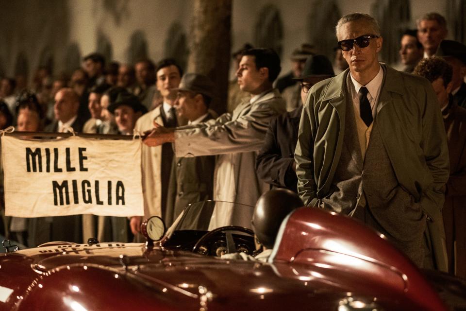 Enzo Ferrari (Adam Driver, in dark glasses at right) is facing the pressure to win the 1957 edition of the Mille Miglia road race in "Ferrari," Michael Mann's new biopic about the legendary Italian sports car builder.