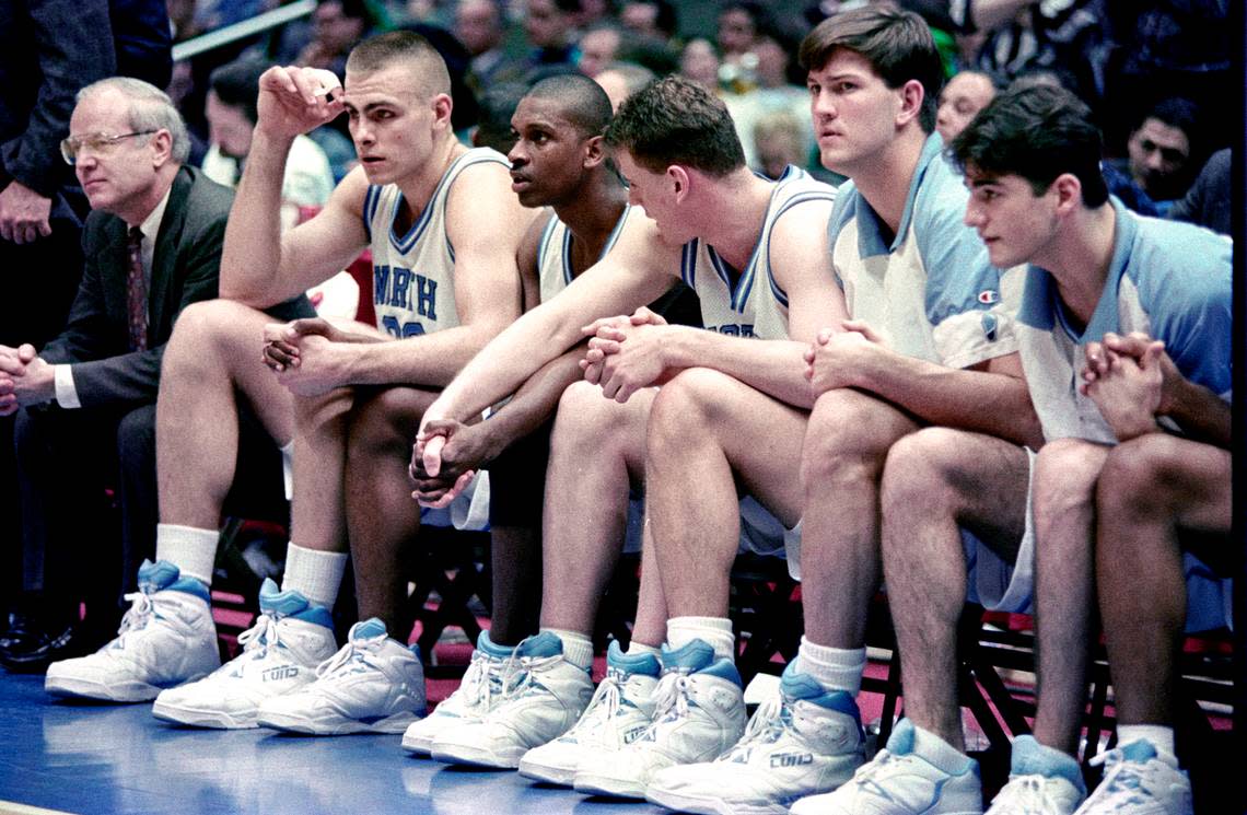 UNC center Eric Montross (second from left) clasps hands with guard Donald Williams as they look on in the closing minutes of an NCAA Tournament win over Cincinnati in 1993.
