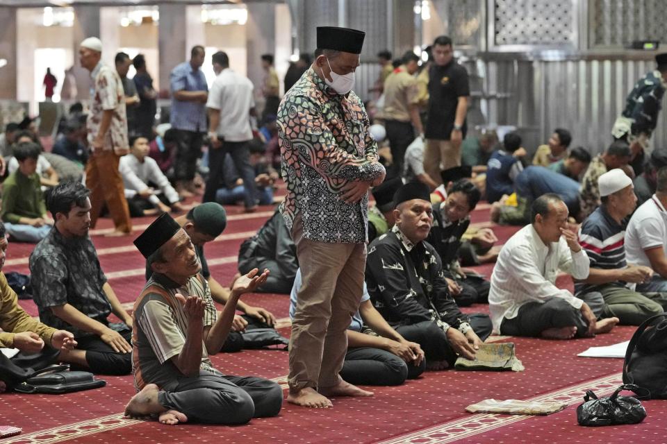 Muslim men pray at Istiqlal Mosque whose electricity partially come from solar power in Jakarta, Indonesia, Wednesday, March 29, 2023. (AP Photo/Tatan Syuflana)