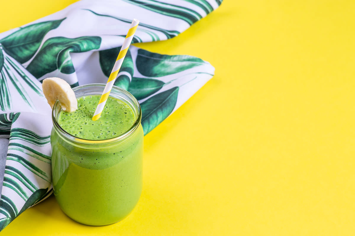 A green smoothie is photographed. 