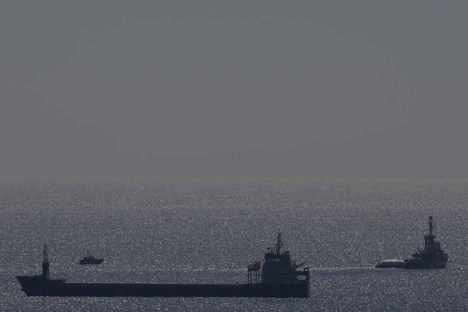 The ship, right, belonging to the Open Arms aid group with aid on a platform ferry some 200 tonnes of rice and flour directly to Gaza, departs from the port of southern city of Larnaca, Cyprus, Tuesday, March 12, 2024. An aid ship loaded with some 200 tons of food set sail Tuesday from Cyprus to Gaza, the international charity behind the effort said. The shipment is a test for the opening of a sea corridor to supply aid to the territory, where starvation is spreading five months into the Israel-Hamas war. (AP Photo/Petros Karadjias)