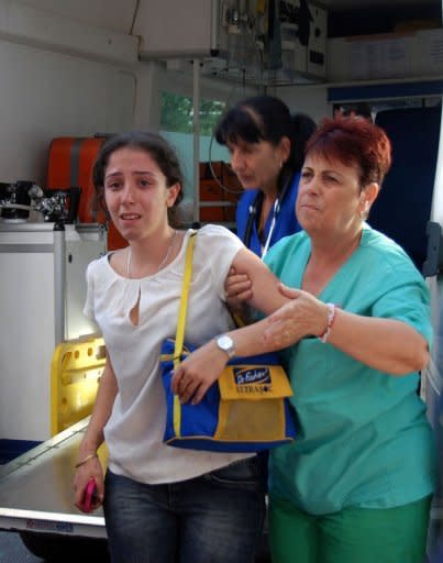 Bulgarian medic help a wounded woman at a hospital after an explosion at Bourgas airport. An explosion ripped through a bus carrying Israeli holiday-makers in Bulgaria and killed at least six people on Wednesday in an attack the government in Israel blamed on arch foe Iran