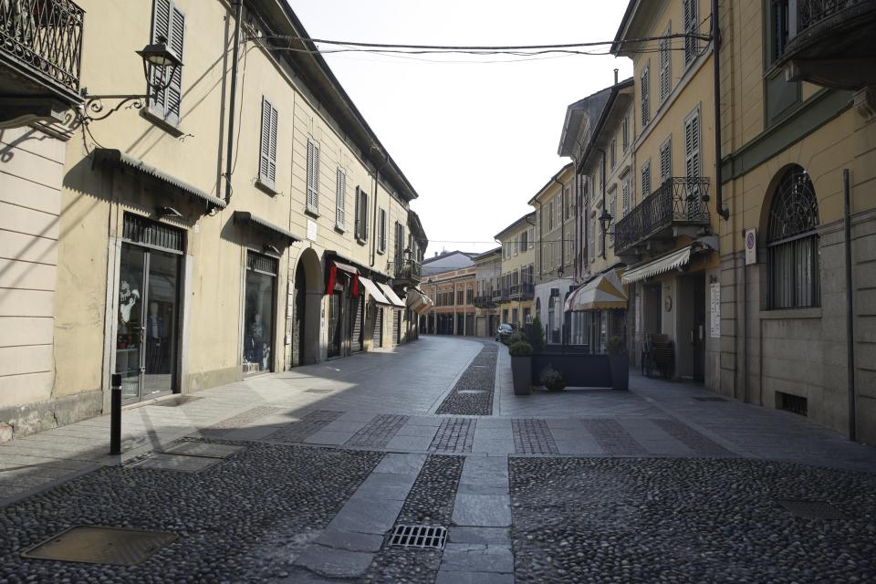 A deserted street in the town of Codogno, near Lodi, Northern Italy, Saturday, Feb. 22, 2020. A dozen northern Italian towns were on effective lockdown Saturday after the new virus linked to China claimed two fatalities in Italy and sickened an increasing number of people who had no direct links to the origin of the virus. The secondary contagions prompted local authorities in towns in Lombardy and Veneto to order schools, businesses and restaurants closed, and to cancel sporting events and Masses. (AP Photo/Luca Bruno)