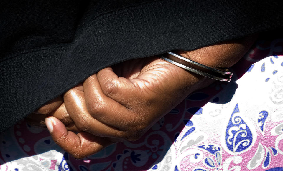 Peoples in handcuffs on April 18, 2013. (Photo: Bruce Chambers/SCNG/ZUMA)