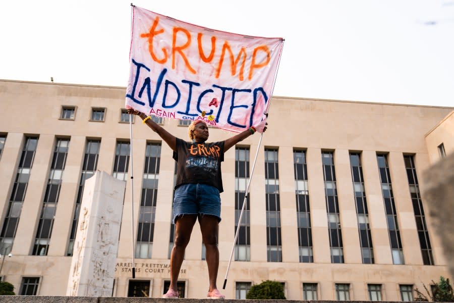 A protester displays a sign outside the E. Barrett Prettyman U.S. District Court House in Washington, D.C., on Tuesday, Aug. 1, 2023. (Photo by Demetrius Freeman/The Washington Post via Getty Images)