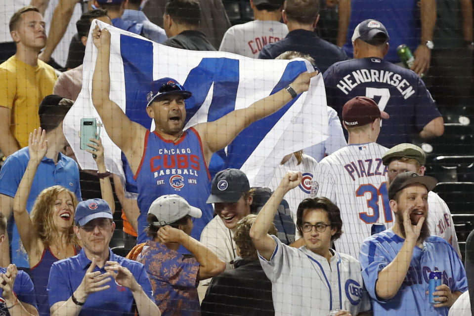 Chicago Cubs' fans celebrate the team's three baseball game sweep of the New York Mets, Thursday, Aug. 29, 2019, in New York. (AP Photo/Kathy Willens)