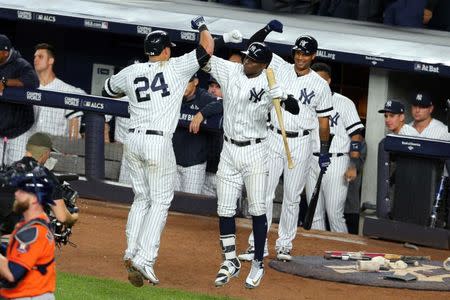 Oct 18, 2017; Bronx, NY, USA; New York Yankees catcher Gary Sanchez (24) celebrates with shortstop Didi Gregorius (18) after hitting a home run during the seventh inning against the Houston Astros in game five of the 2017 ALCS playoff baseball series at Yankee Stadium. Mandatory Credit: Brad Penner-USA TODAY Sports