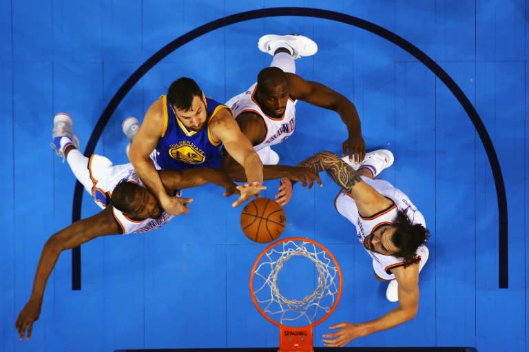 Andrew Bogut (2L) of the Golden State Warriors shoots against Kevin Durant, Serge Ibaka, and Steven Adams of the Oklahoma City Thunder during game six of the Western Conference Finals