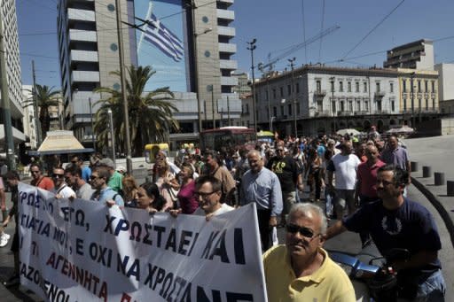 Municipal workers march in central Athens on Wednesday as part of a 48-hours strike protesting spending cutbacks and the government's latest austerity measures. The Greek Prime minister's coalition partners are balking at planned cuts to pensions and benefits, and reductions in the pay of army and police staff