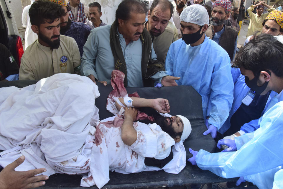 Paramedics and volunteers carry an injured victim of a bomb explosion upon arrival at a hospital, in Quetta, Pakistan, Friday, Sept. 29, 2023. A powerful bomb exploded at a rally celebrating the birthday of Islam's Prophet Muhammad in southwest Pakistan on Friday, killing multiple people and wounding dozens of others, police and a government official said. (AP Photo/Arshad Butt)