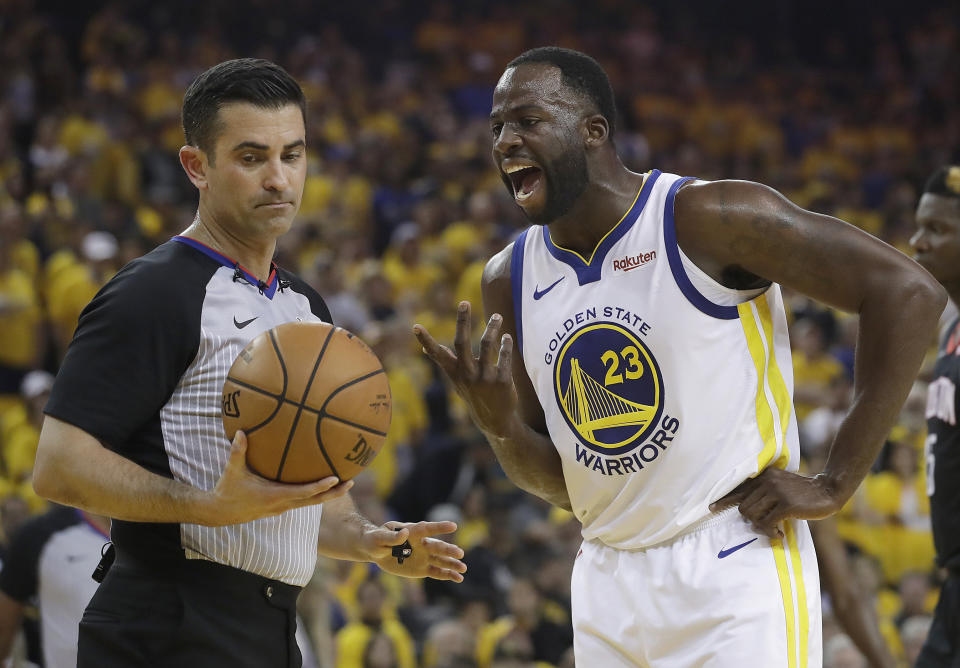 Golden State Warriors forward Draymond Green (23) argues with referee Zach Zarba during the first half of Game 1 of a second-round NBA basketball playoff series against the Houston Rockets in Oakland, Calif., Sunday, April 28, 2019. (AP Photo/Jeff Chiu)