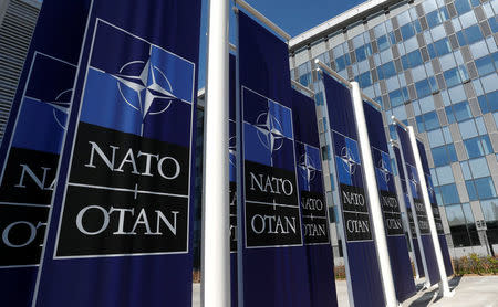 Banners displaying the NATO logo are placed at the entrance of new NATO headquarters during the move to the new building, in Brussels, Belgium April 19, 2018. REUTERS/Yves Herman