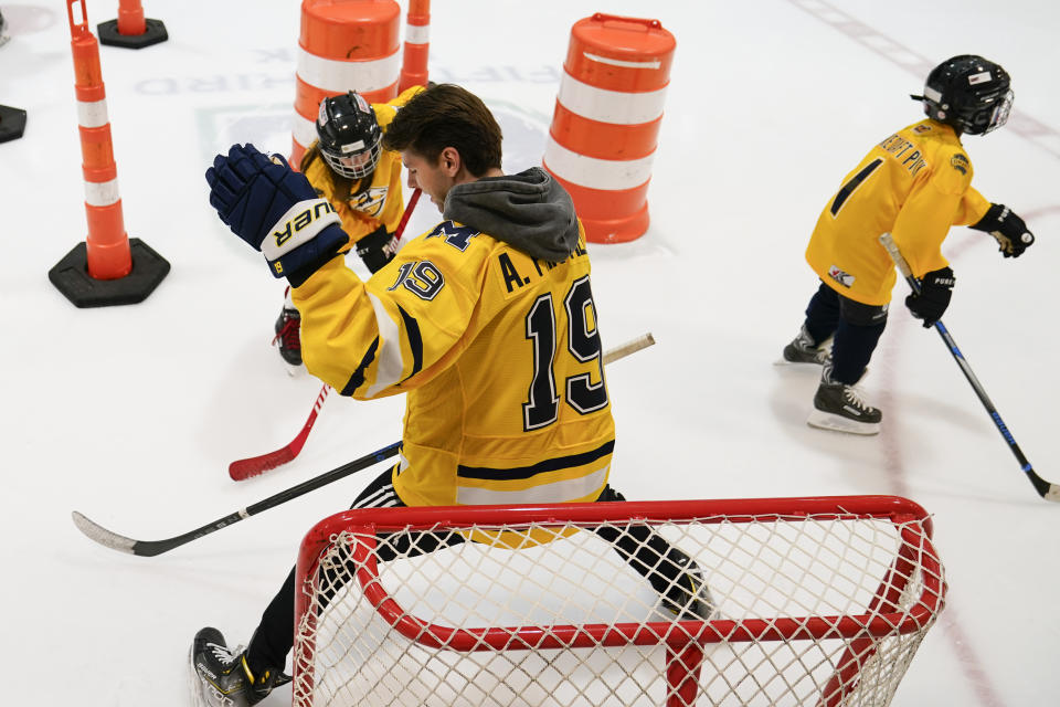 NHL draft prospect Adam Fantilli (19) defends the goal against a participant of a youth hockey clinic with other draft prospects and members of the NHL Player Inclusion Coalition, Tuesday, June 27, 2023, in Nashville, Tenn. (AP Photo/George Walker IV)