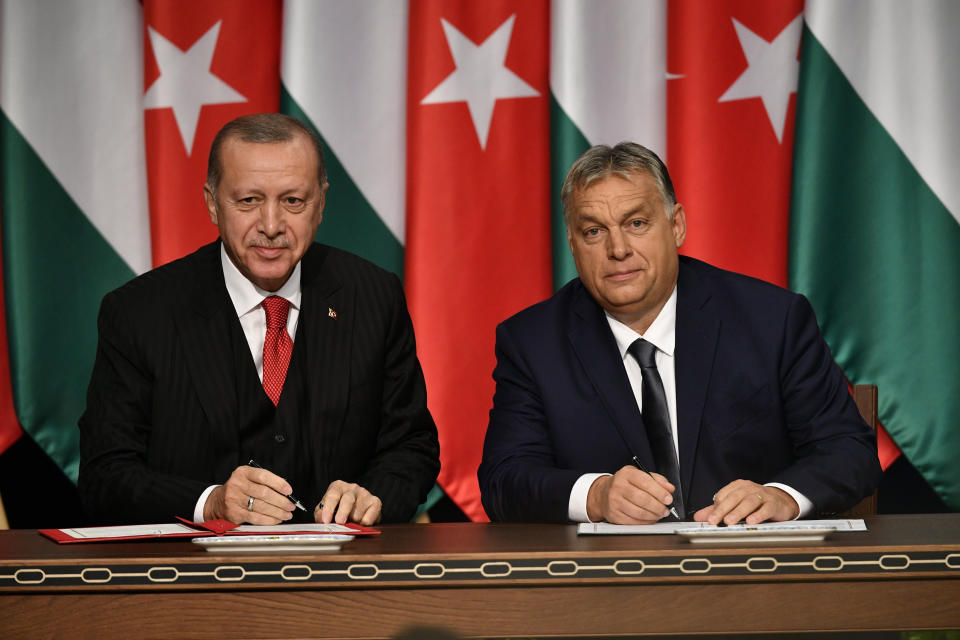 Turkish President Recep Tayyip Erdogan, left, and Hungarian Prime Minister Viktor Orban sign a document during their meeting in Budapest, Hungary, Thursday, Nov. 7, 2019. (Zsolt Szigetvary/MTI via AP)