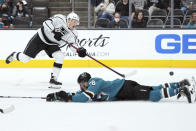 Los Angeles Kings defenseman Mikey Anderson (44) shoots as San Jose Sharks defenseman Mario Ferraro, bottom, attempts to block during the second period of an NHL hockey game in San Jose, Calif., Monday, Jan. 17, 2022. (AP Photo/Darren Yamashita)