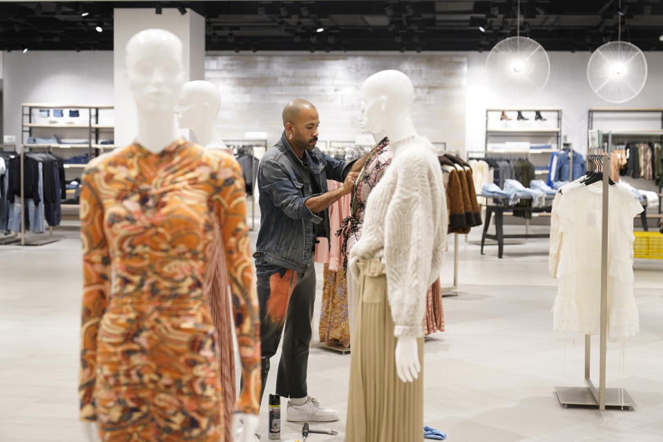 Displays are readied for customers before the opening of Saks Fifth Avenue at the American Dream mall in East Rutherford, N.J., Wednesday, Sept. 15, 2021. If you build it during a pandemic, will they still come? American Dream put that to the test when it opened the new luxury shopping wing of its megamall in September. The new wing comes as the world grapples with the highly contagious delta variant of the coronavirus, which continues to threaten life — and business — from returning to normal. (AP Photo/Seth Wenig)