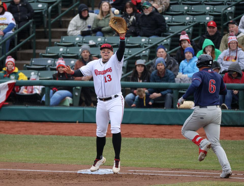 Red Wings first baseman Travis Blankenhorn goes up to reach the ball and get Lehigh Valley hitter John Hicks on Opening Day.