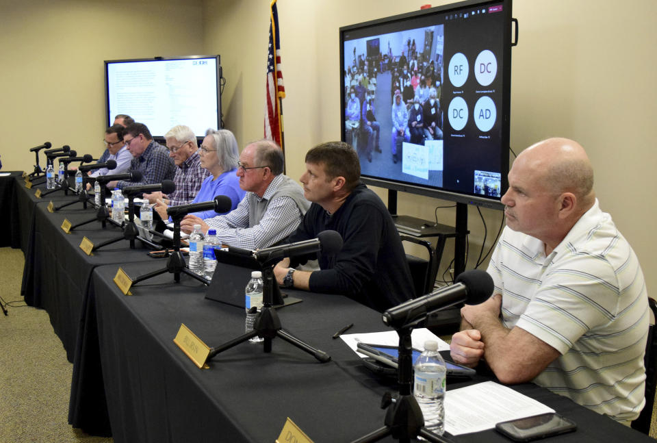 Members of the McMinn County School Board listen to a speaker during a meeting, Thursday, Feb. 10, 2022, in Athens, Tenn. The board heard from concerned citizens about the removal of the Pulitzer Prize-winning graphic novel about the Holocaust "Maus," from the district's curriculum at the meeting. (Robin Rudd/Chattanooga Times Free Press via AP)