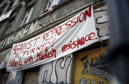 A banner hangs on a squatter house in Berlin, Germany, April 13, 2016. The words read "Against repression in Turkey! Solidarity with Kurdish resistance". REUTERS/Hannibal Hanschke