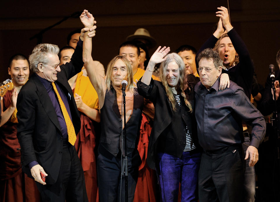 Co-founder of Tibet House U.S. Robert Thurman, left, singer Patti Smith, musician Iggy Pop and composer Philip Glass celebrate during the finale at the 24th Annual Tibet House U.S. benefit concert at Carnegie Hall on Tuesday, March 11, 2014 in New York. (Photo by Evan Agostini/Invision/AP)