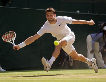 Jul 4, 2014; London, United Kingdom; Grigor Dimitrov (BUL) in action during his match against Novak Djokovic (SRB) on day 11 of the 2014 Wimbledon Championships at the All England Lawn and Tennis Club. Susan Mullane-USA TODAY Sports