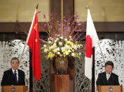 China' Foreign Minister Wang Yi, left, and his Japanese counterpart Toshimitsu Motegi participate in a press briefing in Tokyo on Tuesday, Nov. 24, 2020. Wang met Motegi on Tuesday to discuss ways to revive their pandemic-hit economies as well as regional concerns over China’s growing influence. (Issei Kato/Pool Photo via AP)