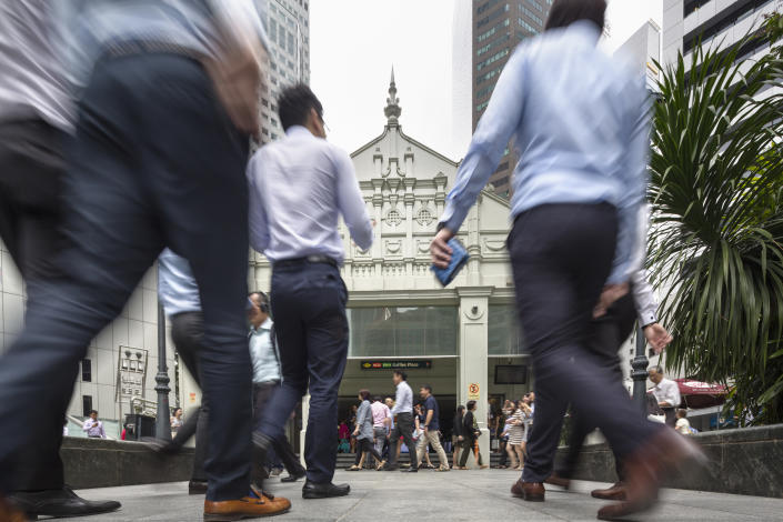 Office workers walking at Raffles Place. 