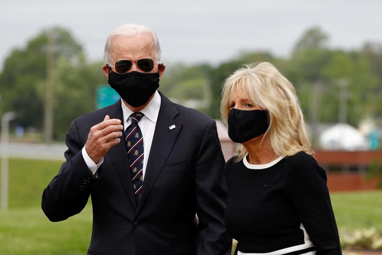 Covering up: Joe Biden and wife Jill as they attend commemorations in Delaware: AP