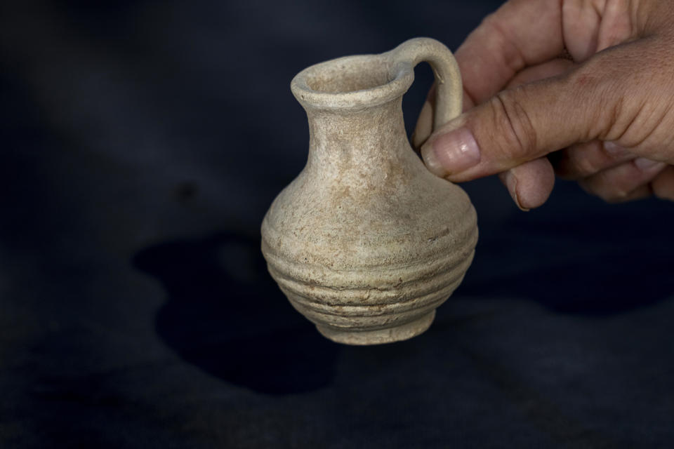 An artifact is displayed from a 1,200-year-old rural estate discovered during excavations by the Israel Antiquities Authority during expansion of the town of Rahat, Israel, Tuesday, Aug. 23, 2022. Located in Israel's south near the Bedouin town of Rahat, the building dates back back to the early Islamic period in the 8th or 9th centuries. (AP Photo/Tsafrir Abayov)