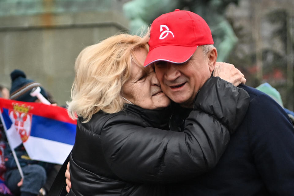 Seen here, Novak Djokovic's father Srdan is hugged by a supporter of the tennis star during a protest rally in Belgrade.