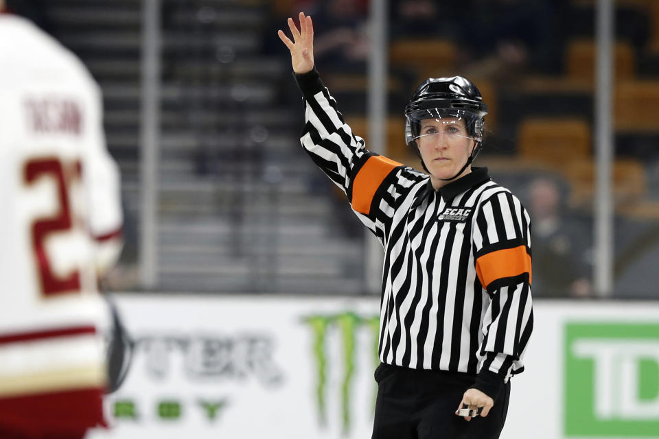 CORRECTS SPELLING TO WELSH, NOT WALSH - FILE - In this Feb 4, 2019, file photo, referee Katie Guay watches a Boston College line change during a Beanpot Tournament NCAA college hockey game against Harvard in Boston. Guay and Kirsten Welsh were among four females selected by the NHL on Friday, Sept. 6, 2019, to be the first women to work as on-ice officials at several prospect tournaments taking place across the country this weekend. The other two women selected were Kelly Cooke and Kendall Hanley. (AP Photo/Winslow Townson, FIle)