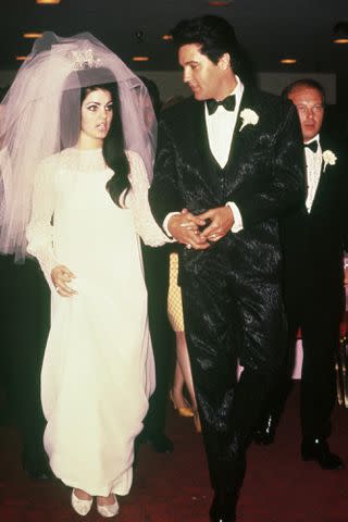 <p>Snap/Shutterstock</p> Elvis Presley and Priscilla Ann Beaulieu following their wedding on May 1, 1967.