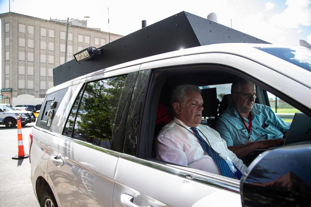 WDIV's Rod Meloni, letft, edits track for 6 p.m. news in the vehicle with photographer Tim Pamplin during "Live From Detroit: The Concert at Michigan Central" in the Corktown neighborhood of Detroit on Thursday, June 6, 2024.