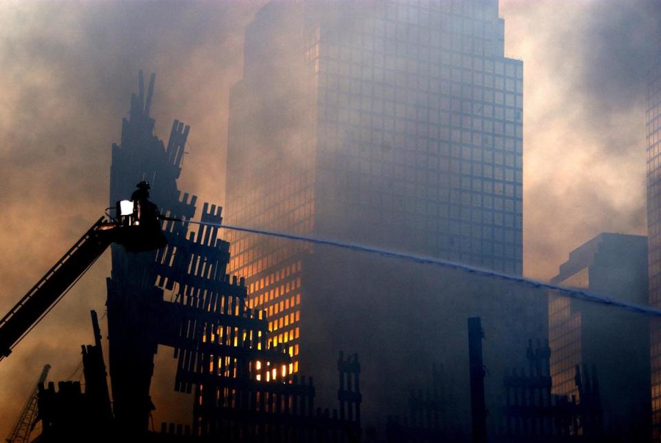 Firefighters fight the fires that sprout up from within the rubble of the World Trade Center in New York City Sept 19, 2001, days after the 9/11 attack.