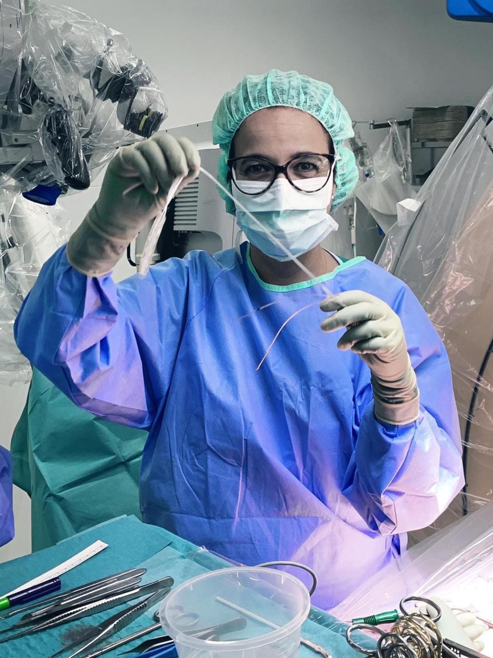 Neurosurgeon Jocelyn Bloch demonstrates the electrode she implants in patients with spinal cord injuries.