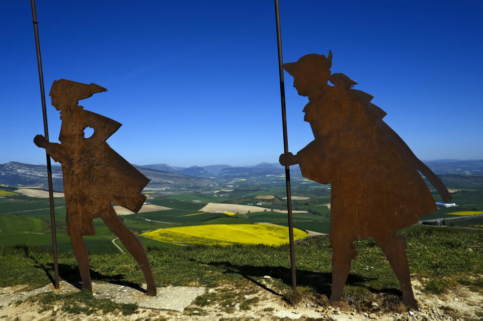 Sculptures representing St. James Way pilgrims are seen on top of a hill on the way to Santiago de Compostela around 15 kms, 9,3 miles, from Pamplona, northern Spain, Thursday, April 14, 2021. The pilgrims are trickling back to Spain's St. James Way after a year of being kept off the trail due to the pandemic. Many have committed to putting their lives on hold for days or weeks to walk to the medieval cathedral in Santiago de Compostela in hopes of healing wounds caused by the coronavirus. (AP Photo/Alvaro Barrientos)