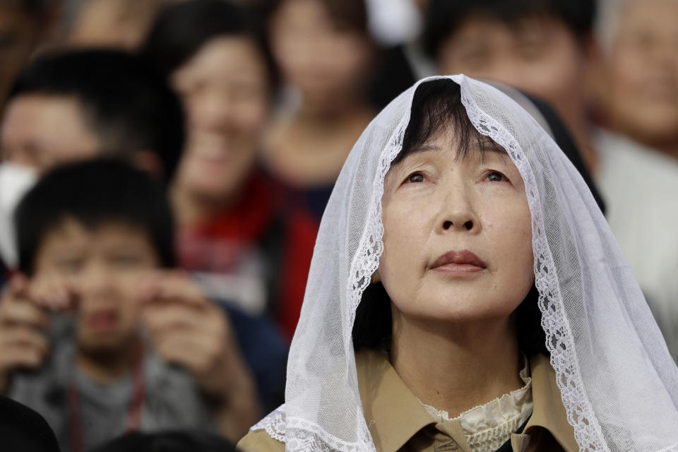 The faithful attend a Mass held by Pope Francis at a baseball stadium Sunday, Nov. 24, 2019, in Nagasaki, Japan. (AP Photo/Gregorio Borgia)