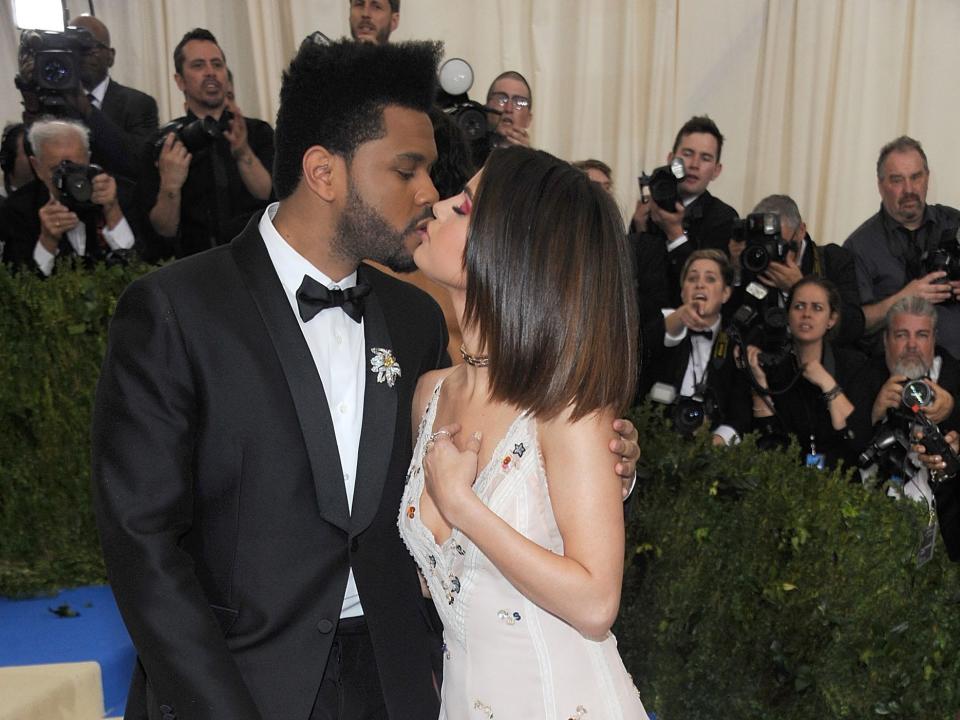 Selena Gomez and the Weeknd kiss at the 2017 Met Gala.