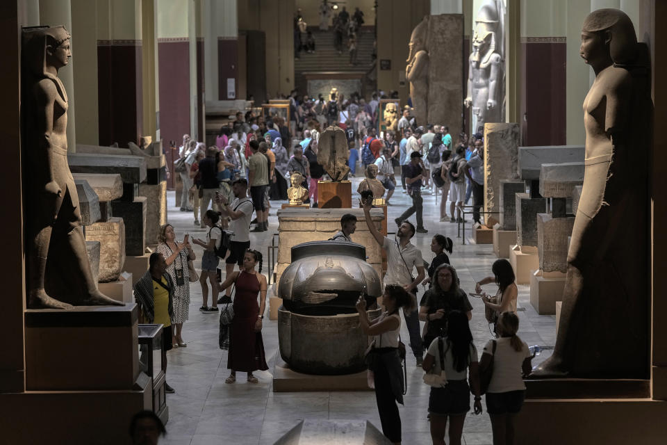 Hundreds of tourists watch and film antiquities at the Egyptian museum in Cairo, Egypt, Wednesday, Sept. 27, 2023. The country is aiming at reaching 30 million visitors by 2028, as its once-thriving tourism sector has begun to recover from the fallout of the coronavirus pandemic and the grinding war in Europe, Egypt's Tourism and Antiquities Minister Ahmed Issa said during an interview with the Associated Press. (AP Photo/Amr Nabil)