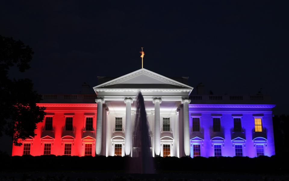 The White House is bathed in red, white and blue light as part of the Fourth of July celebration - Getty