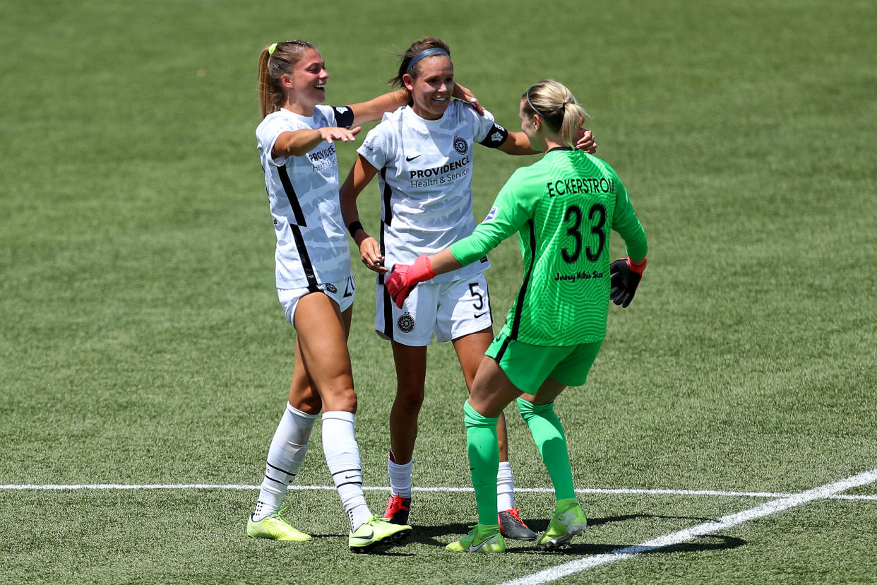 Thorns goalkeeper Britt Eckerstrom (33) celebrates with teammates Emily Menges and Kelli Hubly after upsetting the North Carolina Courage in the NWSL Challenge Cup. (Photo by Maddie Meyer/Getty Images)