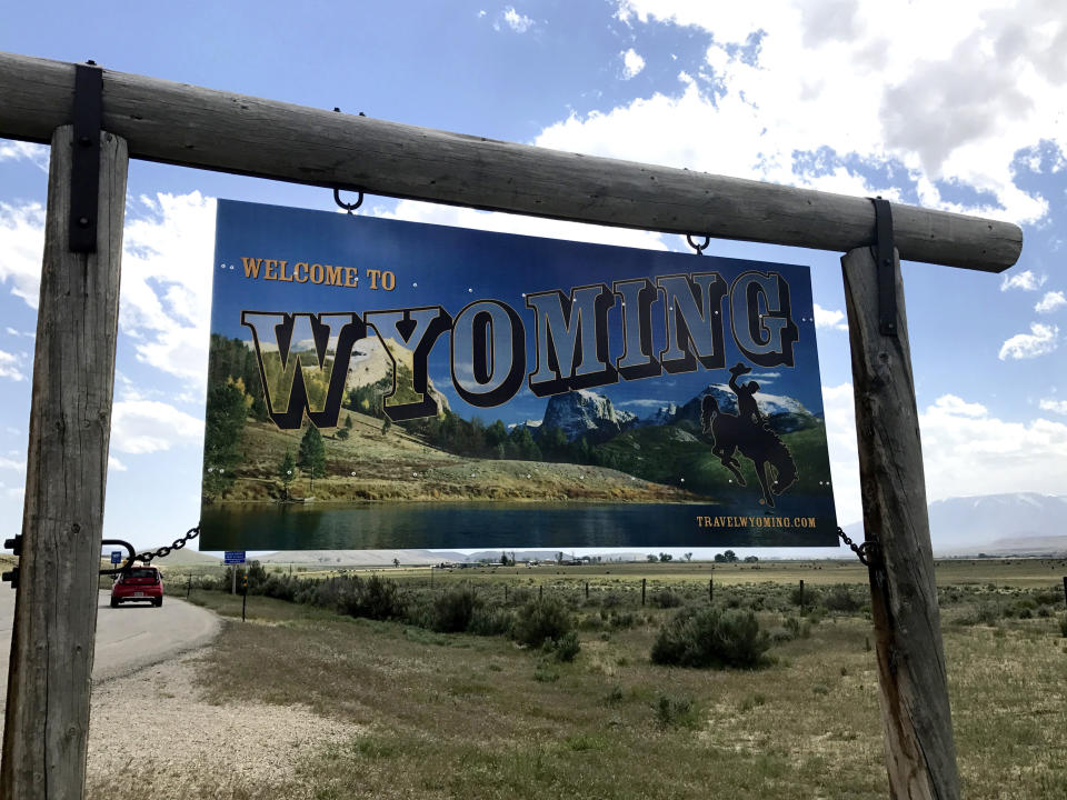 FILE - A sign on the border of Wyoming and Montana appears on the side of Belfry Highway, May 24, 2017, in Powell, Wyo. President Joe Biden will face Democratic voters this Saturday, April 13, 2024, in a pair of nominating contests in Alaska and Wyoming that are unlikely to produce any surprises. In Wyoming, Democrats will award 13 delegates using a presidential preference vote held at 23 county-level caucuses. (AP Photo/Robert Yoon, File)