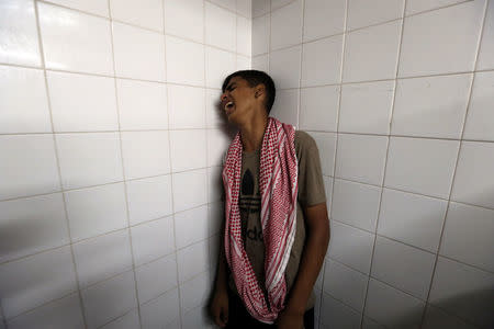 A relative of Palestinian Mohammad Al-Hamayda, who was killed by Israeli forces during a protest at the Israel-Gaza border, reacts at a hospital in the southern Gaza Strip June 29, 2018. REUTERS/Ibraheem Abu Mustafa