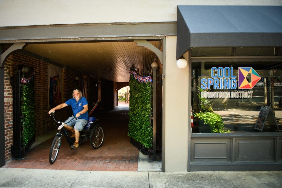 Cool Spring Downtown District Ambassador Mark Dodd heads out on his tricycle to check on things and pick up trash in the downtown area on Tuesday, July 11, 2023.