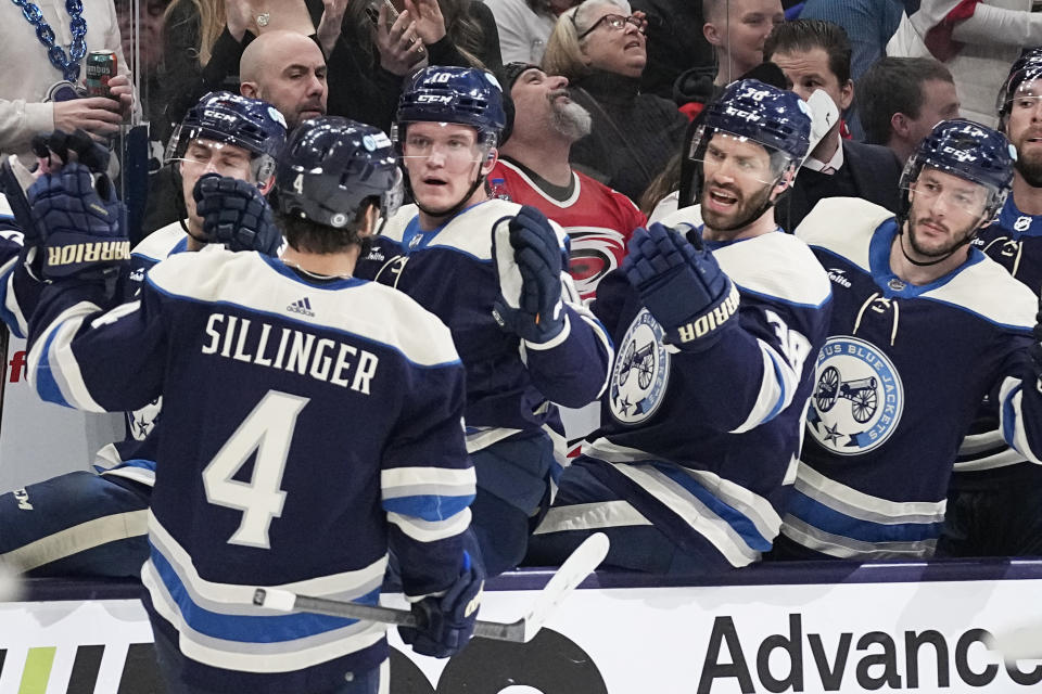 Columbus Blue Jackets center Cole Sillinger (4) is congratulated by teammates for his goal against the Carolina Hurricanes during the second period of an NHL hockey game Thursday, Feb. 29, 2024, in Columbus, Ohio. (AP Photo/Sue Ogrocki)