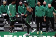 Boston Celtics' Jaylen Brown, center, limps off the court after colliding with teammate Jayson Tatum during the second half of an NBA basketball game against the Portland Trail Blazers, Sunday, May 2, 2021, in Boston. (AP Photo/Michael Dwyer)