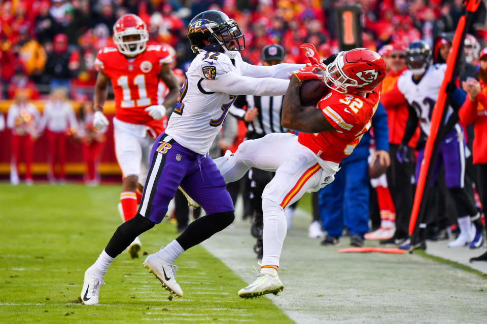 <p>Eric Weddle #32 of the Baltimore Ravens knocks Spencer Ware #32 of the Kansas City Chiefs out of bounds during the second quarter of the game at Arrowhead Stadium on December 9, 2018 in Kansas City, Missouri. (Photo by Peter Aiken/Getty Images) </p>