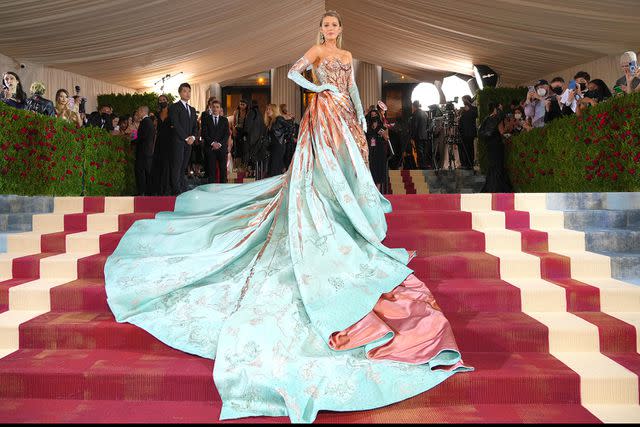 <p>Getty Images</p> Blake Lively shows off her reversible Atelier Versace gown on the iconic steps at the 2022 Met Gala